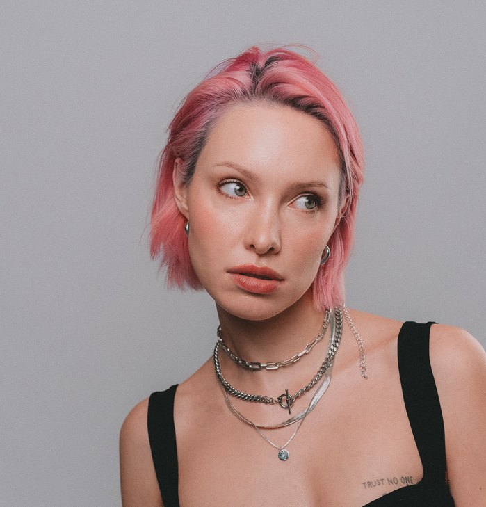 Asia with pink hair looking to the side, silver chains