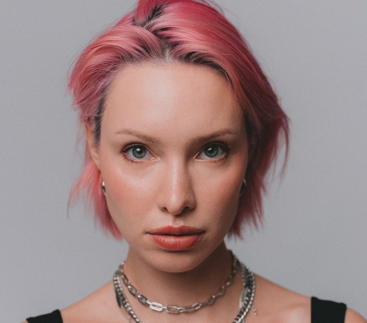 Asia with pink hair facing the camera