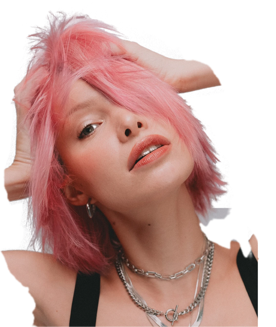 Asia with pink shaggy hair, one hand in her hair, silver chains
