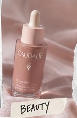 Serum bottle on pink satin