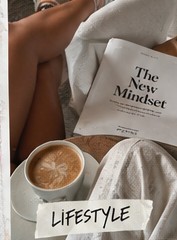 Coffee and a magazine on white sheets